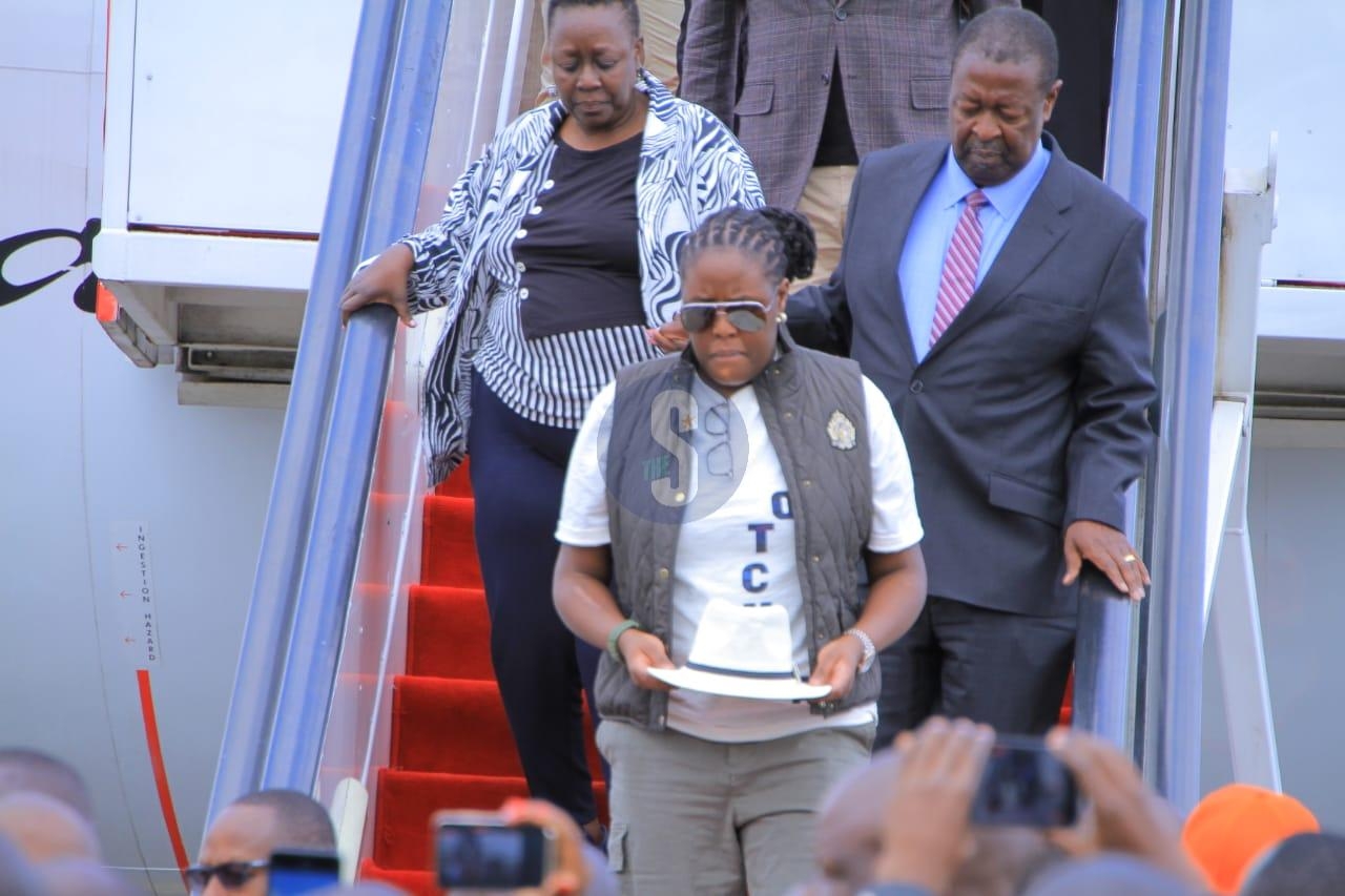The Journey Home: Winnie Odinga carries Raila’s iconic white hat at JKIA