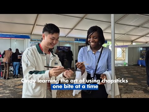 Cindy learning the art of using chopsticks — one bite at a time
